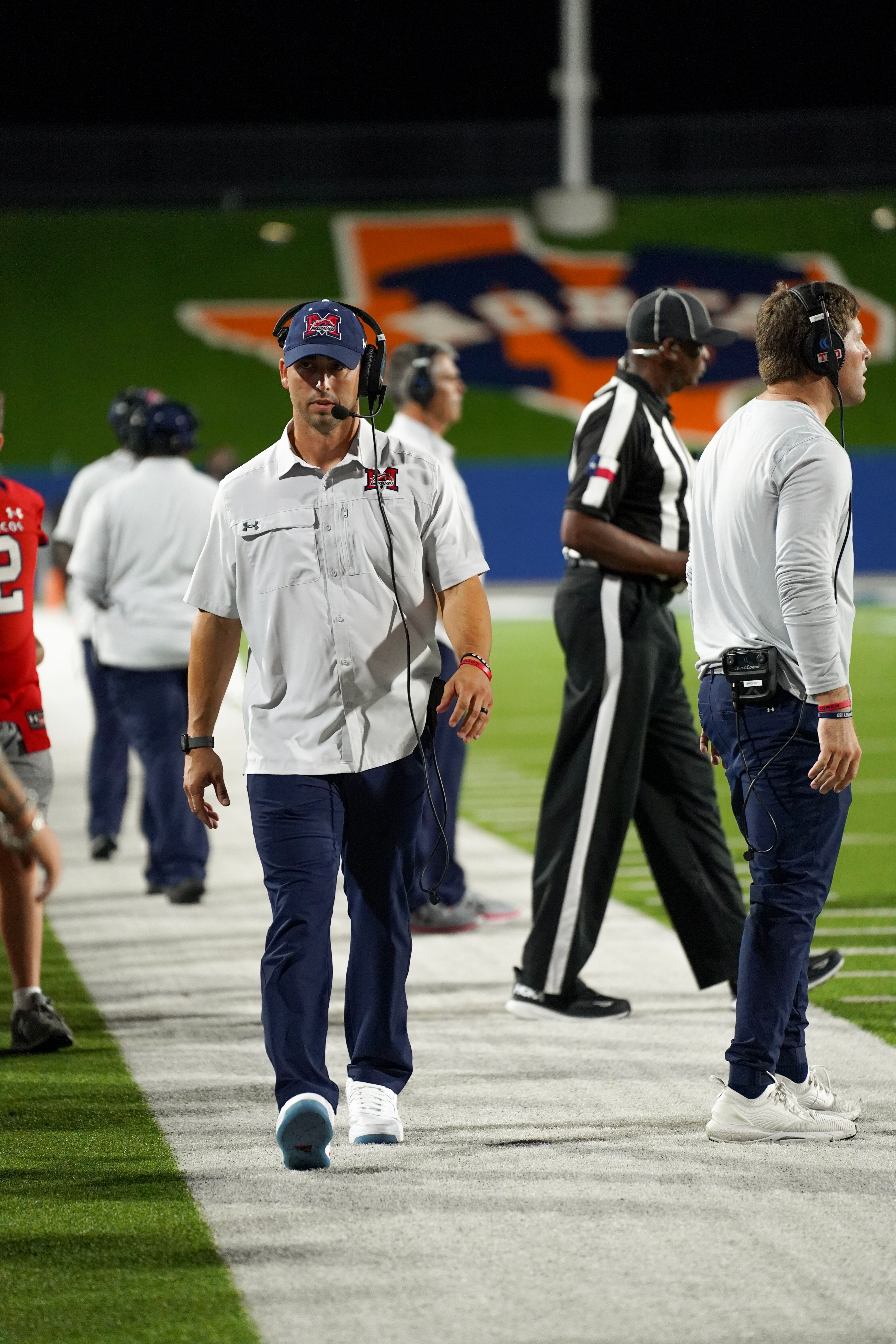 McKinney Boyd Broncos coach walking the sideline during a Friday night game